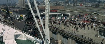 Movie still from “The Brain” (1969), directed by Gérard Oury – A crowd of people walking on a bridge; Extreme Wide shot, High angle