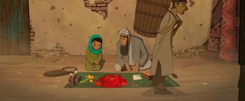 Movie still from “The Breadwinner” (2017), directed by Nora Twomey – An illustration of a man and a woman kneeling on the ground; Wide shot, Overhead angle