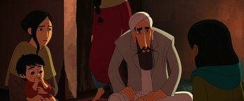 Movie still from “The Breadwinner” (2017), directed by Nora Twomey – An animated man with a beard is sitting on the ground; Medium shot, Over the shoulder angle
