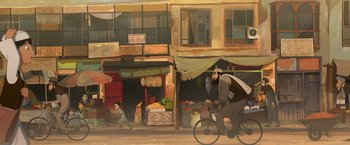 Movie still from “The Breadwinner” (2017), directed by Nora Twomey – A man riding a bike down a street near a market; Wide shot, Low angle