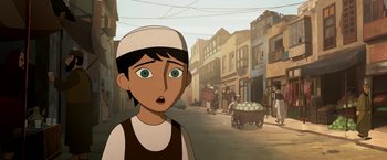Movie still from “The Breadwinner” (2017), directed by Nora Twomey – An animated scene of a boy with a white hat and a cart of eggs; Close Up shot, Over the shoulder angle