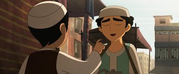 Movie still from “The Breadwinner” (2017), directed by Nora Twomey – Two people standing next to each other on a city street; Close Up shot, Over the shoulder angle