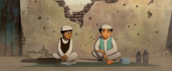 Movie still from “The Breadwinner” (2017), directed by Nora Twomey – Two men sitting on the ground in front of a brick wall; Medium shot, Over the shoulder angle