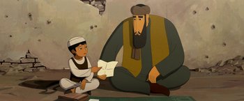 Movie still from “The Breadwinner” (2017), directed by Nora Twomey – An animated scene of a man and a boy reading a book; Medium shot, Over the shoulder angle