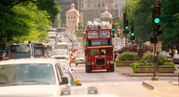 Movie still from “The Break-Up” (2006), directed by Peyton Reed – A red double decker bus driving down a street; Extreme Wide shot, Over the shoulder angle