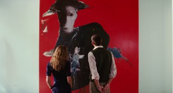 Movie still from “The Break-Up” (2006), directed by Peyton Reed – A man and a woman standing in front of a red wall; Medium shot, Over the shoulder angle