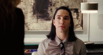 Movie still from “The Break-Up” (2006), directed by Peyton Reed – A man with long black hair wearing a shirt and tie; Close Up shot, Over the shoulder angle