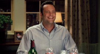 Movie still from “The Break-Up” (2006), directed by Peyton Reed – A man sitting at a table with a bottle of wine; Close Up shot, Over the shoulder angle