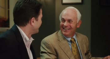 Movie still from “The Break-Up” (2006), directed by Peyton Reed – A man in a suit talking to another man in a suit; Close Up shot, Over the shoulder angle