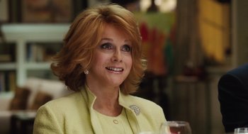 Movie still from “The Break-Up” (2006), directed by Peyton Reed – A person wearing a suit and smiling; Close Up shot, Over the shoulder angle