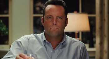 Movie still from “The Break-Up” (2006), directed by Peyton Reed – A person holding a wine glass; Close Up shot, High angle