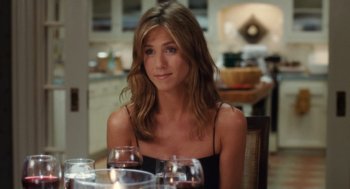 Movie still from “The Break-Up” (2006), directed by Peyton Reed – A woman sitting at a table with a glass of wine in front of her; Close Up shot, High angle