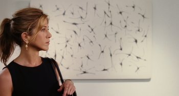 Movie still from “The Break-Up” (2006), directed by Peyton Reed – A woman standing in front of a painting; Medium shot, Low angle