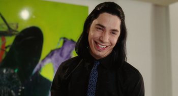 Movie still from “The Break-Up” (2006), directed by Peyton Reed – A man with long black hair wearing a black shirt; Close Up shot, High angle