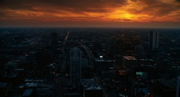 Movie still from “The Break-Up” (2006), directed by Peyton Reed – An aerial view of a city at night with the sun going down; Extreme Wide shot, High angle