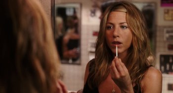 Movie still from “The Break-Up” (2006), directed by Peyton Reed – A woman putting lipstick on in front of a mirror; Close Up shot, Over the shoulder angle