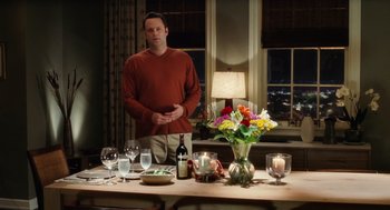 Movie still from “The Break-Up” (2006), directed by Peyton Reed – A man standing in front of a dining room table; Medium shot, Over the shoulder angle
