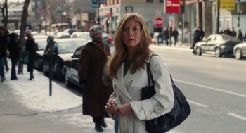 Movie still from “The Break-Up” (2006), directed by Peyton Reed – A woman is walking down the street holding a cell phone; Medium shot, Over the shoulder angle