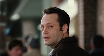 Movie still from “The Break-Up” (2006), directed by Peyton Reed – A person wearing a brown jacket; Close Up shot, Low angle