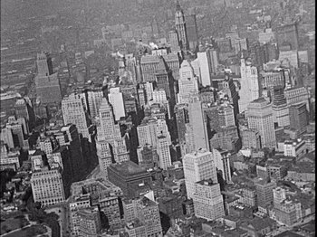 Movie still from “The Broadway Melody” (1929), directed by Harry Beaumont – An aerial view of a large city with skyscrapers; Extreme Wide shot, Overhead angle