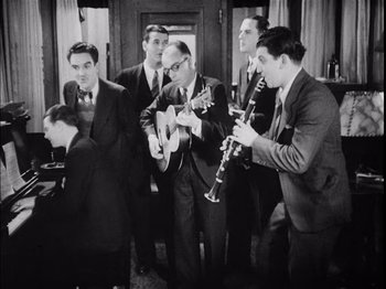 A black and white photo of a group of men playing instruments