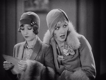 Movie still from “The Broadway Melody” (1929), directed by Harry Beaumont – A couple of women sitting next to each other in a room; Close Up shot, High angle