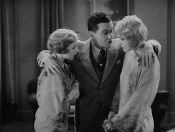 Movie still from “The Broadway Melody” (1929), directed by Harry Beaumont – Two women and a man standing next to each other in a room; Medium shot, High angle