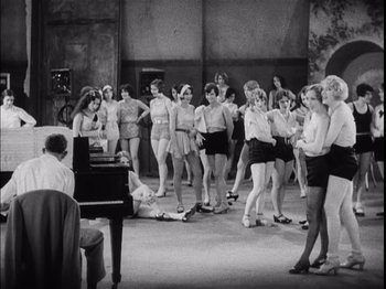Movie still from “The Broadway Melody” (1929), directed by Harry Beaumont – A black and white photo of a group of women in bathing suits; Wide shot, High angle