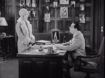 A man and a woman sitting at a desk