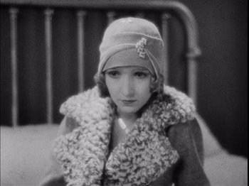 Movie still from “The Broadway Melody” (1929), directed by Harry Beaumont – An old photo of a woman wearing a hat; Close Up shot, High angle