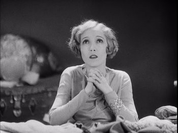 Movie still from “The Broadway Melody” (1929), directed by Harry Beaumont – An old photo of a woman looking up to the sky; Close Up shot, Low angle