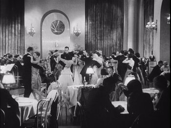 Movie still from “The Broadway Melody” (1929), directed by Harry Beaumont – A black and white photo of people dancing in a restaurant; Extreme Wide shot, Low angle