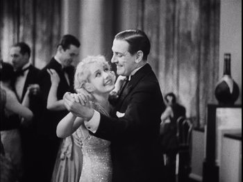 Movie still from “The Broadway Melody” (1929), directed by Harry Beaumont – A man and a woman are dancing in front of other people; Medium shot, Low angle