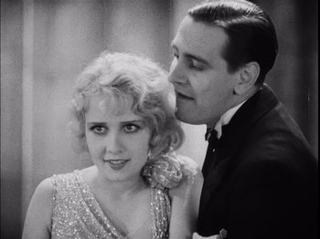 Movie still from “The Broadway Melody” (1929), directed by Harry Beaumont – A man kissing a woman on the side of her shoulder; Close Up shot, Low angle