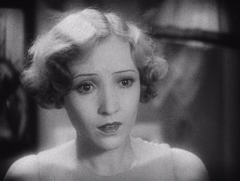 Movie still from “The Broadway Melody” (1929), directed by Harry Beaumont – An old black and white photo of a woman; Close Up shot, High angle