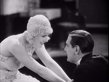Movie still from “The Broadway Melody” (1929), directed by Harry Beaumont – A man and a woman holding each other's hands; Medium shot, Over the shoulder angle