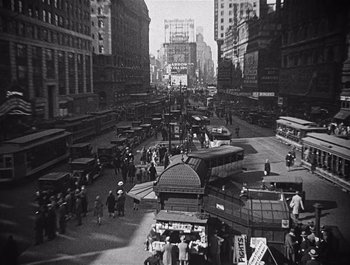 Movie still from “The Broadway Melody” (1929), directed by Harry Beaumont – A black and white photo of a busy city street; Extreme Wide shot, High angle