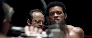 Movie still from “Ali” (2001), directed by Michael Mann – Two men looking at each other in front of a mirror; Close Up shot, Over the shoulder angle