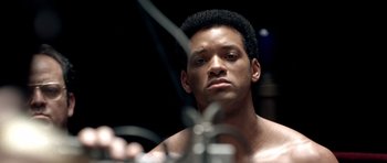 Movie still from “Ali” (2001), directed by Michael Mann – A person with a microphone; Close Up shot, Over the shoulder angle