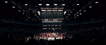 Movie still from “Ali” (2001), directed by Michael Mann – A boxing ring is shown in a boxing ring; Extreme Wide shot, High angle