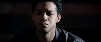 Movie still from “Ali” (2001), directed by Michael Mann – A person wearing a black shirt; Close Up shot, Over the shoulder angle