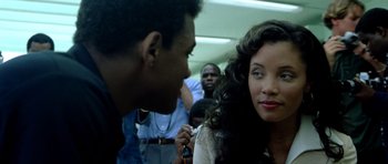 Movie still from “Ali” (2001), directed by Michael Mann – A man and a woman talking to each other on a train; Close Up shot, Over the shoulder angle