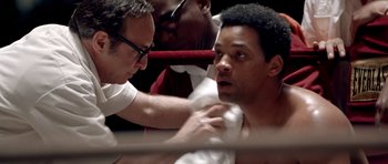 Movie still from “Ali” (2001), directed by Michael Mann – A man in a boxing ring getting his hair combed; Close Up shot, Over the shoulder angle