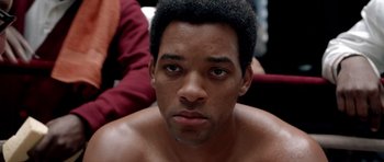 Movie still from “Ali” (2001), directed by Michael Mann – A person with a beard; Close Up shot, Over the shoulder angle