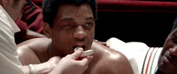 Movie still from “Ali” (2001), directed by Michael Mann – A person brushing his teeth; Close Up shot, Over the shoulder angle