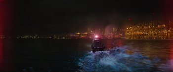 Movie still from “Godzilla vs. Kong” (2021), directed by Adam Wingard – A police boat in the water at night time; Extreme Wide shot, High angle