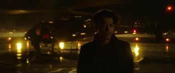 Movie still from “Godzilla vs. Kong” (2021), directed by Adam Wingard – A man standing in the dark in front of a building; Close Up shot, Over the shoulder angle