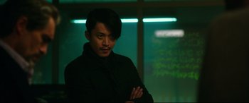 Movie still from “Godzilla vs. Kong” (2021), directed by Adam Wingard – A man in a black jacket standing in front of a window; Close Up shot, Over the shoulder angle