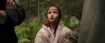 Movie still from “Godzilla vs. Kong” (2021), directed by Adam Wingard – A young girl wearing a white raincoat in the woods; Close Up shot, Low angle