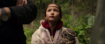 Movie still from “Godzilla vs. Kong” (2021), directed by Adam Wingard – A young girl in a white jacket looking up; Close Up shot, Over the shoulder angle